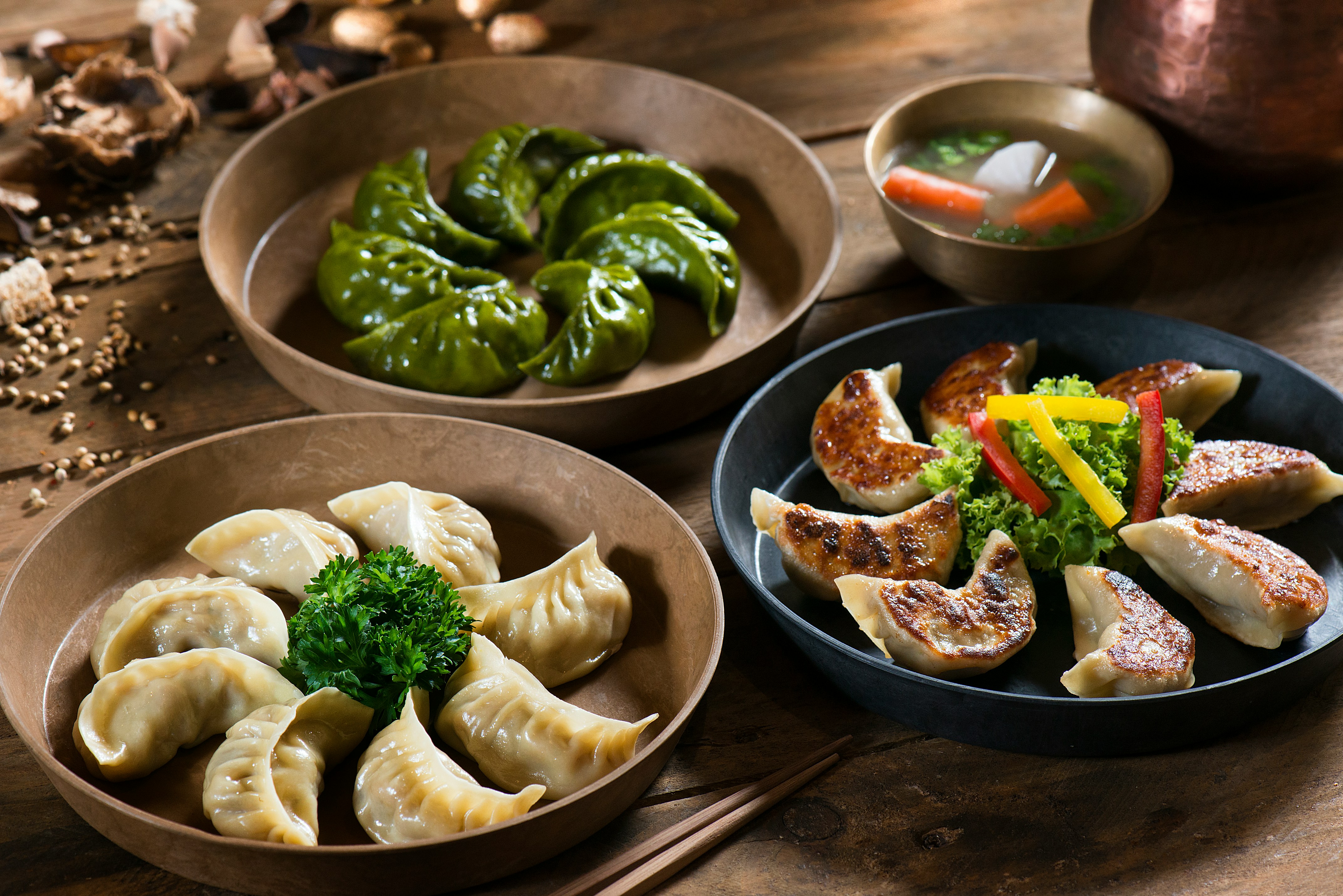 Assorted Chinese dumplings on wooden plates