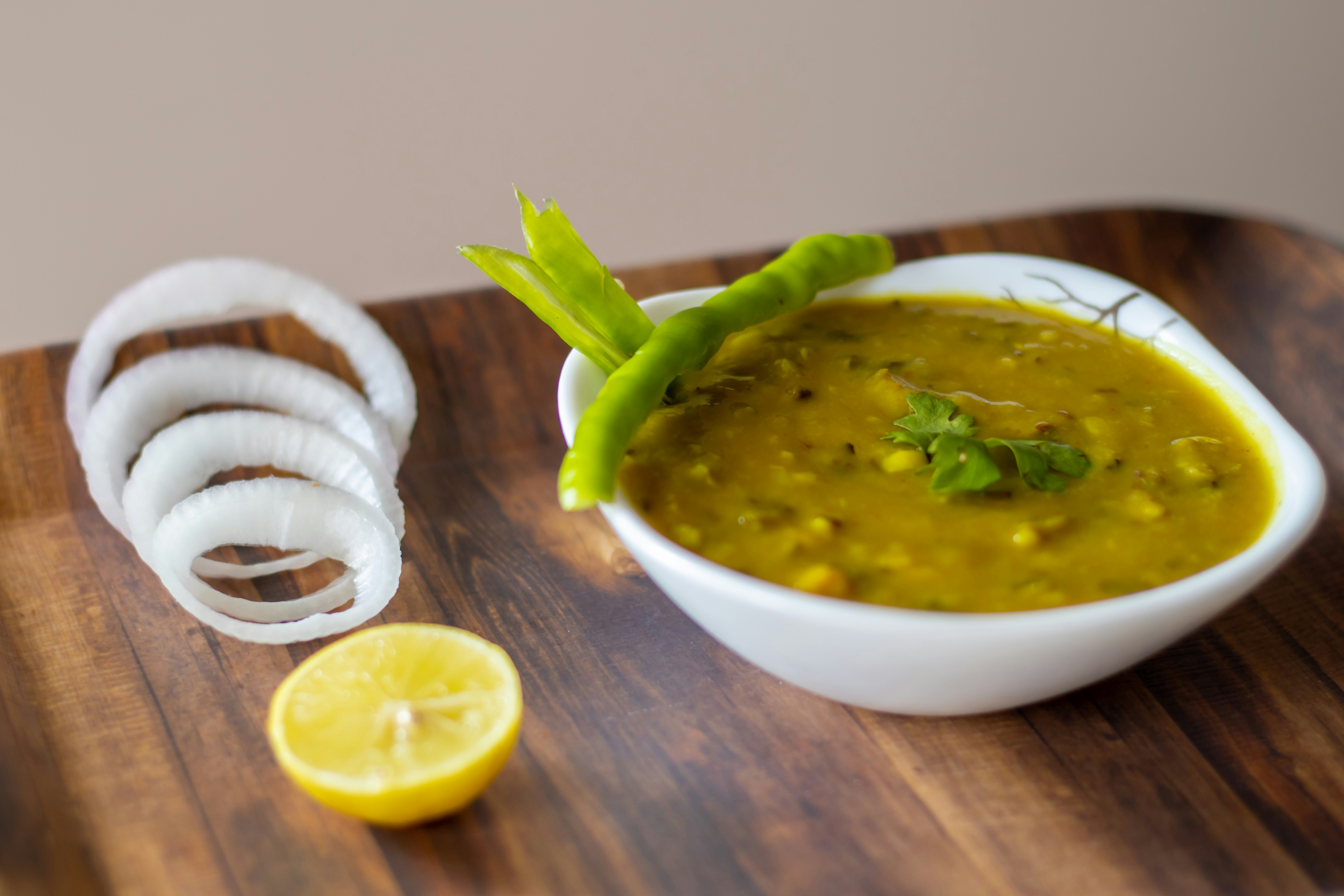 Bowl of golden dal with green chilli garnish