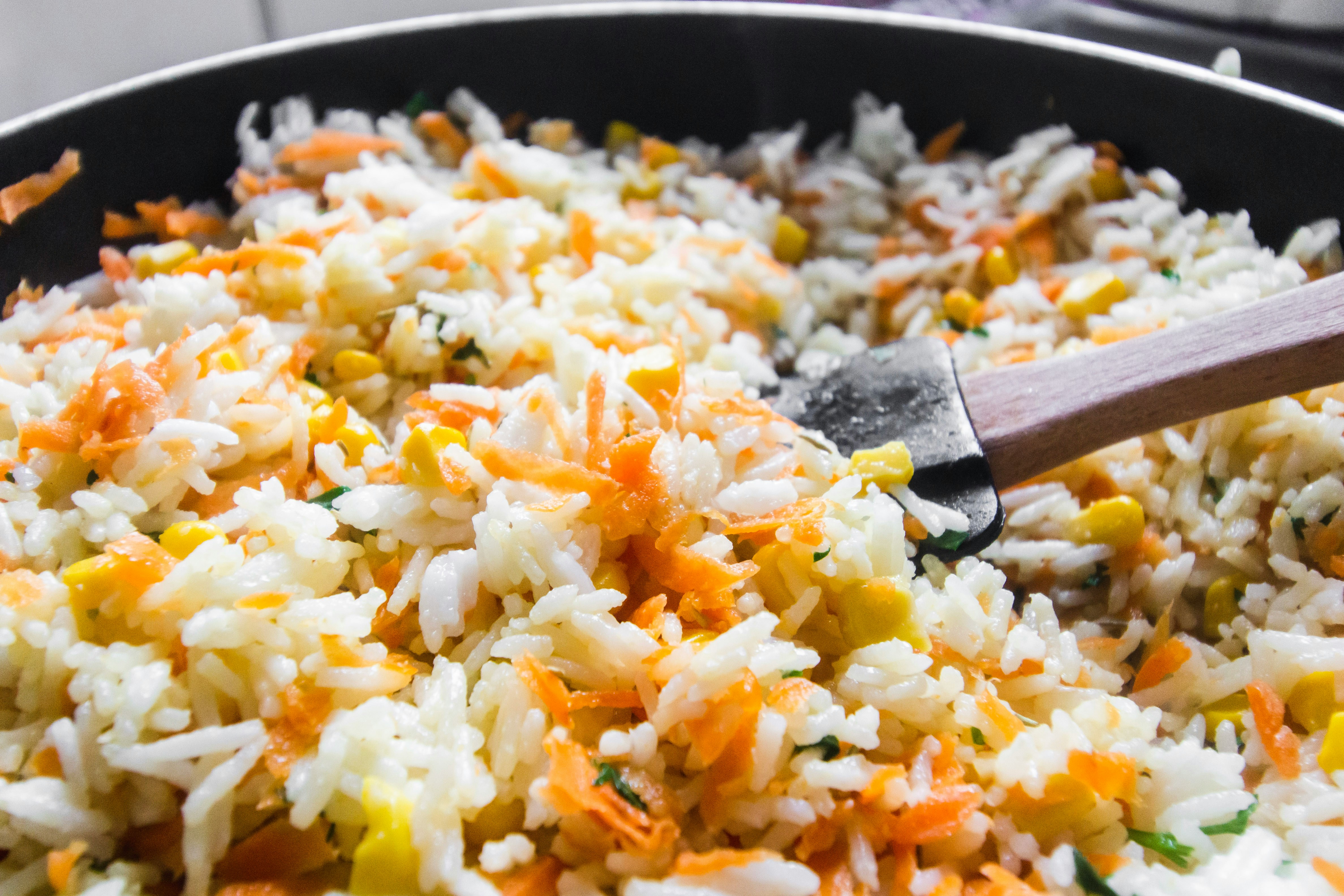 Egg fried rice being cooked in a pan
