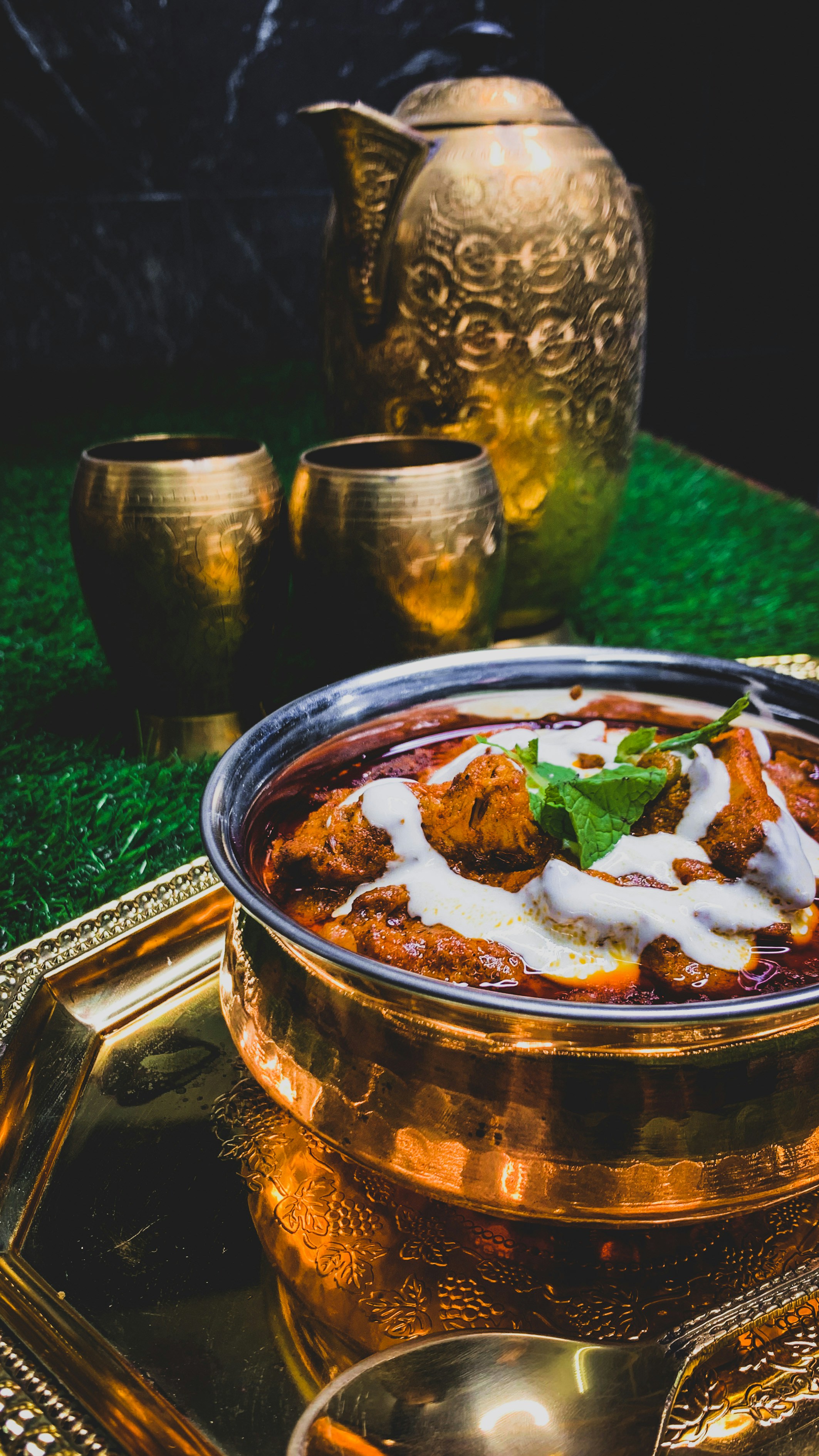 Rich Indian curry in copper pot